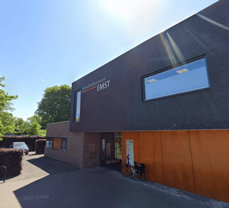Exterior of the Gezondheidscentrum Emst health center building with a bicycle parked outside.