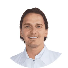 Smiling man with brown hair wearing a white collared shirt