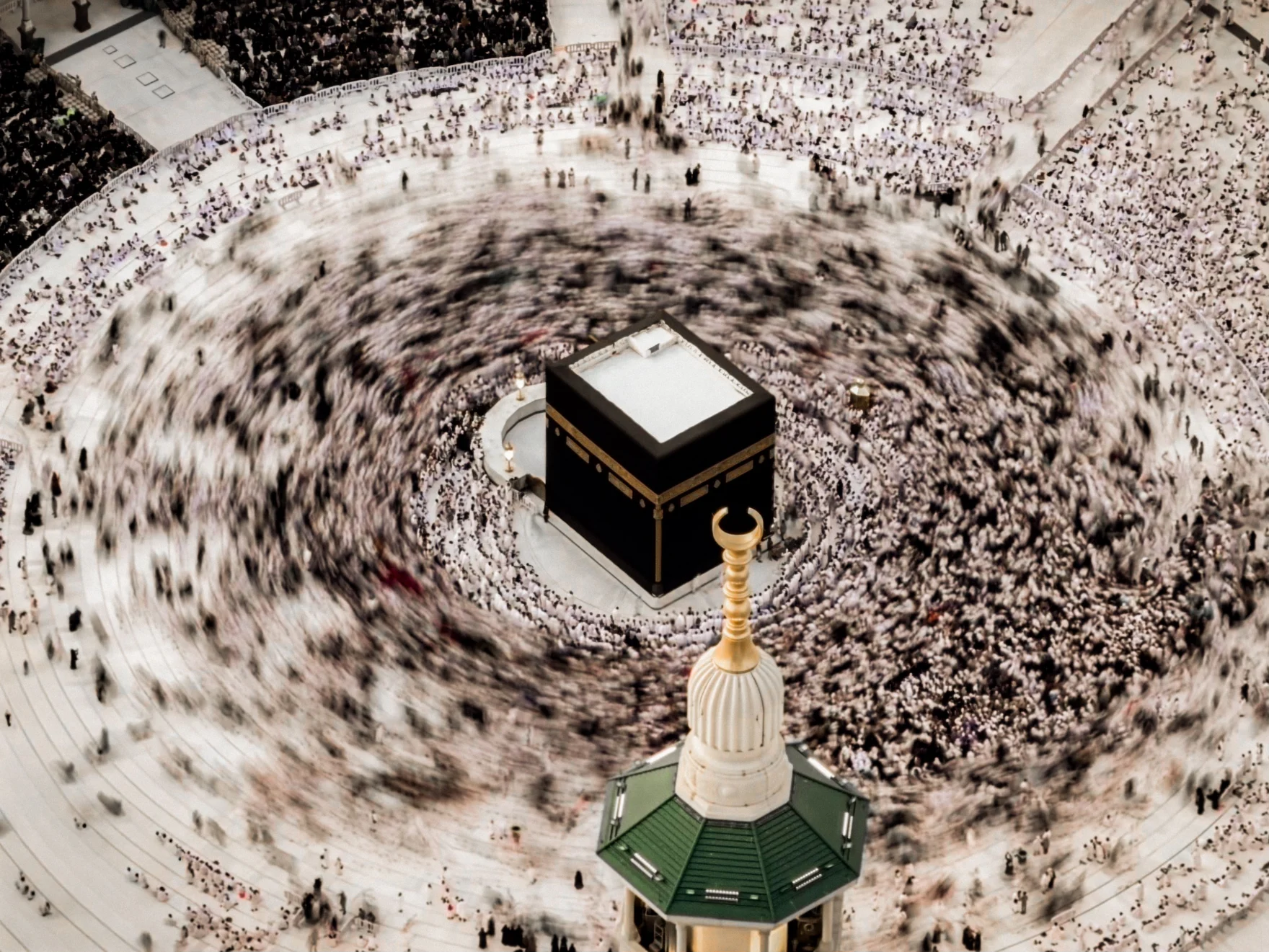 Swirling crowd of pilgrims circumambulating the Kaaba in Mecca, Saudi Arabia.